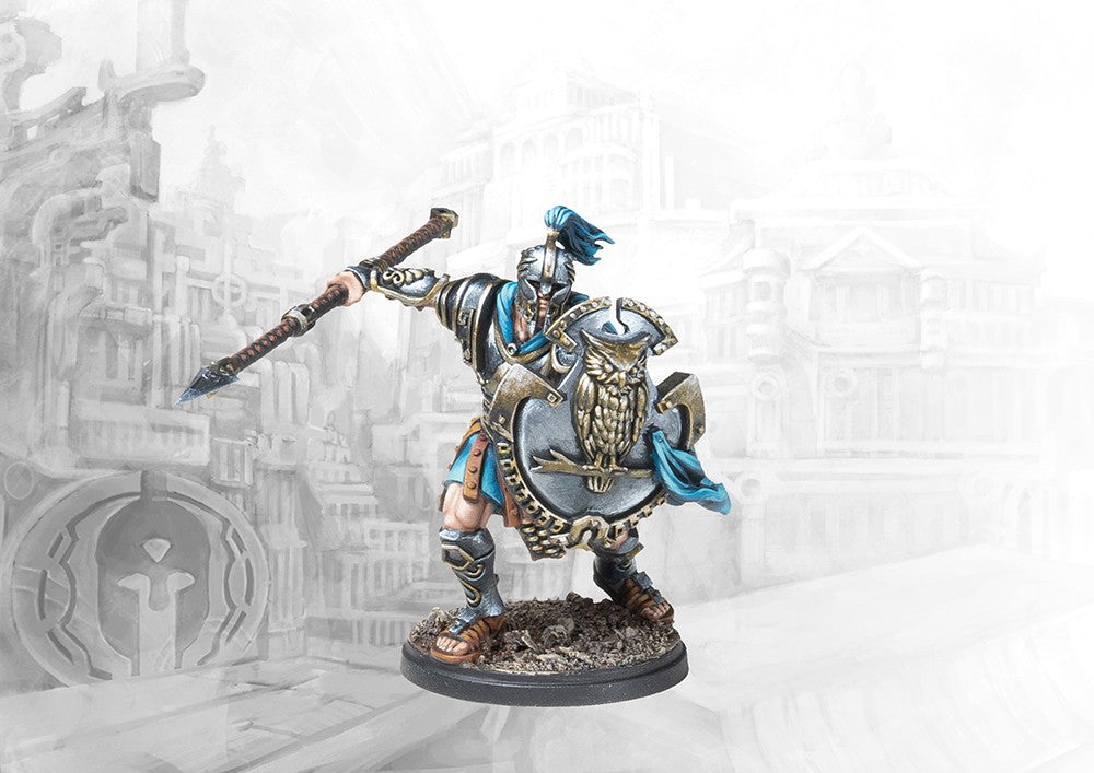 A fully painted City States Dorilates officer miniature for Conquest, holding a spear and a large shield decorated with a prominent owl emblem.