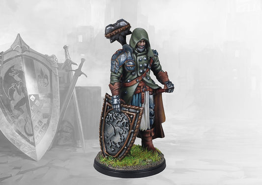 A studio-painted miniature of the Conquest Errant of the Order of the Shield, a hooded warrior holding a large warhammer and an ornate shield.