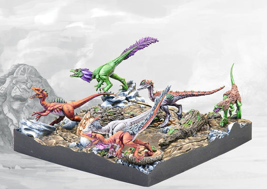 Another view of the W'adrhŭn Hunting Pack miniatures, showing the varied poses and colorful paint schemes of the small, fierce uzibukhali dinosaurs in a pack formation.
