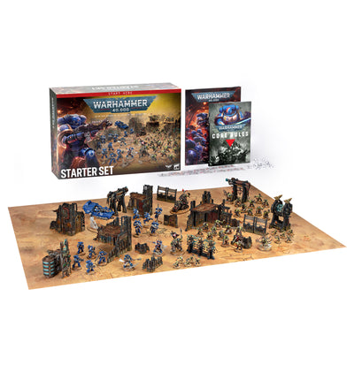 The official retail product box for the Warhammer 40,000 Starter Set, displaying Space Marines, Orks, modular terrain, and handbooks.
