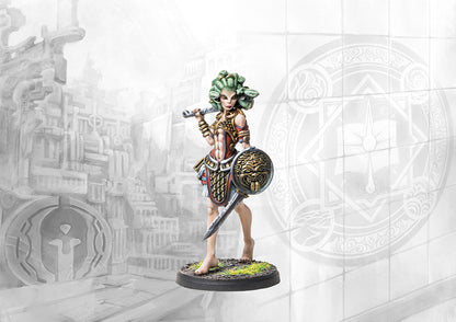 A close-up of the painted City States Gorgon miniature from Conquest: Fanning the Fire, with snake-hair, a large sword, and a decorative shield.