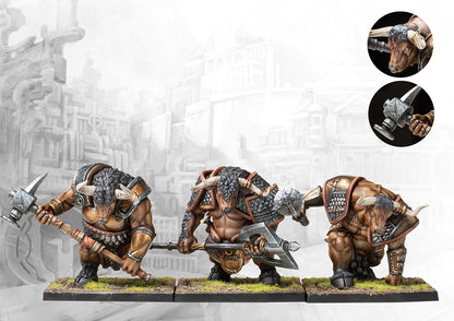 Three fully painted City States Minotaur Thyrean miniatures on square bases, depicted as powerful minotaurs wielding large two-handed axes and hammers.