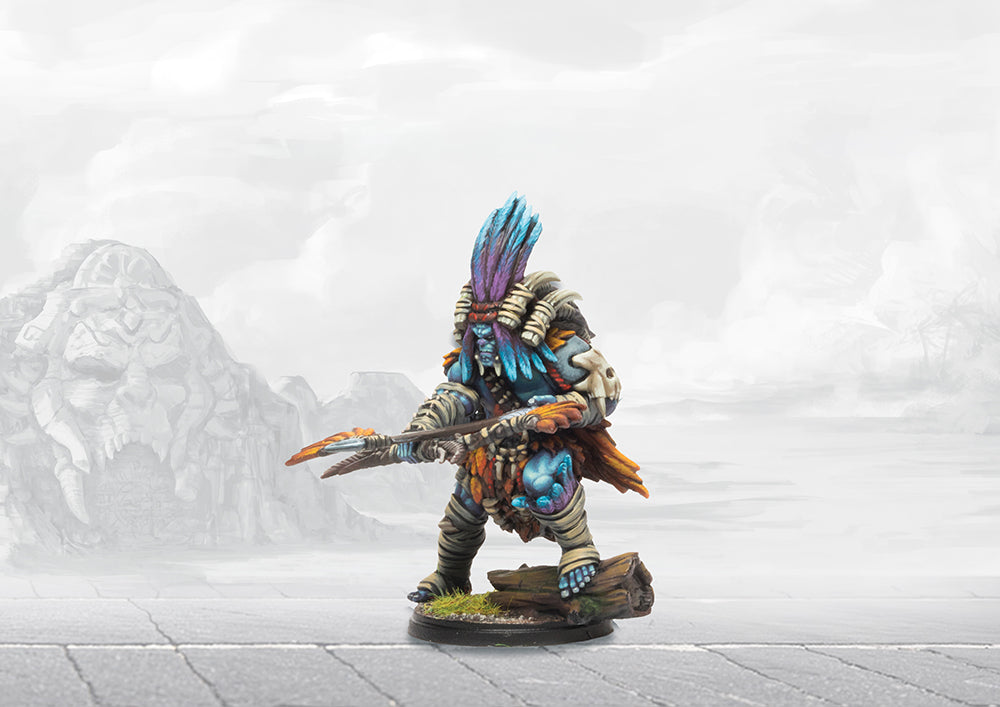 A painted Wadrhun Orc-like warrior miniature, featuring blue skin, bone armor, and a large feathered headdress.