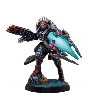 A painted Infinity Combined Army Achilles miniature, a heavily armored cybernetic warrior holding a large gun and an illuminated energy shield.