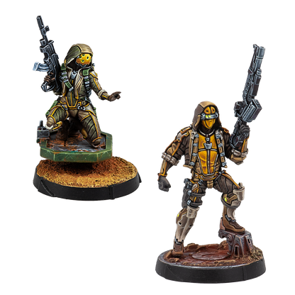 Two painted Infinity Haqqislam Mukthar unit miniatures, featuring soldiers in tan and green camo with yellow visors and rifles.