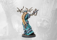 A close-up of the painted Nord Prophetess miniature from Conquest: Ashes and Faith, wearing antlers and teal robes while holding a ceremonial dagger.