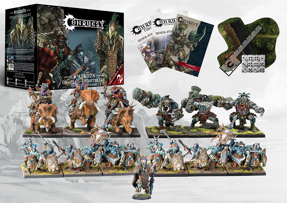 The complete contents of the W'adrhŭn Starter Set laid out, including the Chieftain, Veterans, Thunder Riders (Dinosaur Cavalry), Warbred Brutes, rulebooks, dice, and terrain for First Blood and TLAOK.