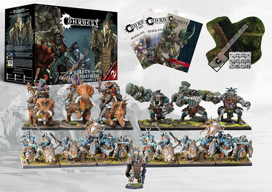The complete contents of the W'adrhŭn Starter Set laid out, including the Chieftain, Veterans, Thunder Riders (Dinosaur Cavalry), Warbred Brutes, rulebooks, dice, and terrain for First Blood and TLAOK.