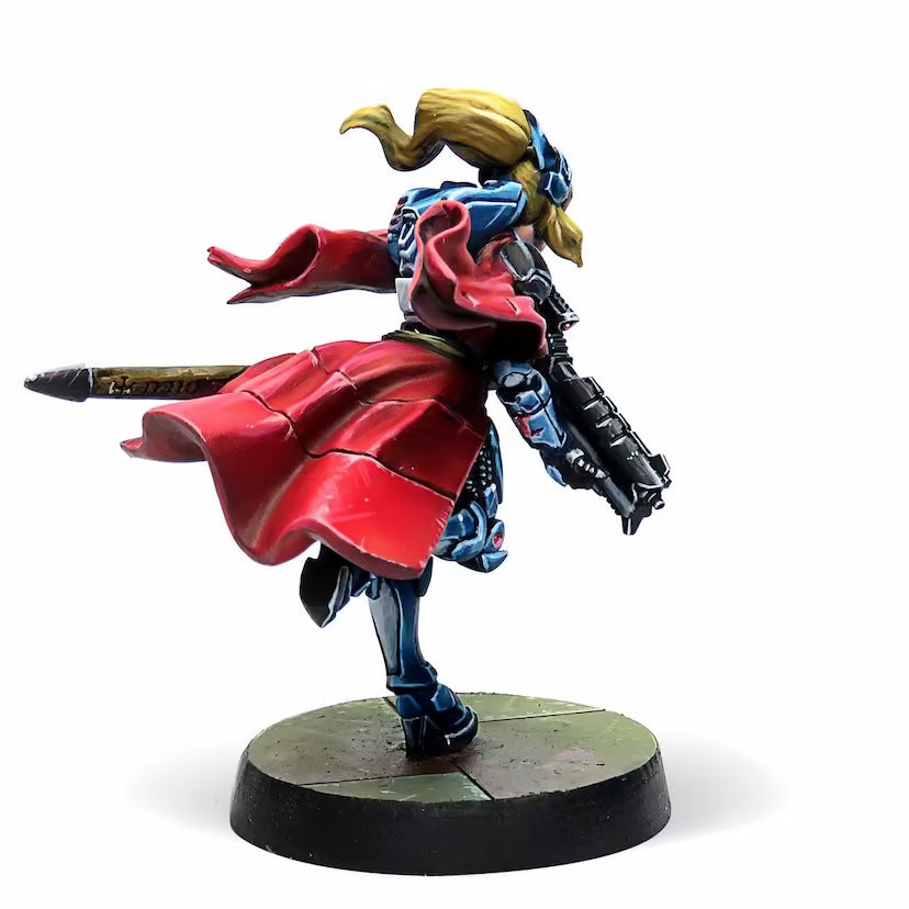 A rear view of the painted Jeanne d'Arc 2.0 Infinity miniature, showcasing the flowing red cape and armor details.