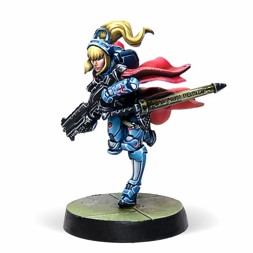 A side view of the painted Jeanne d'Arc 2.0 Infinity miniature, showing the detail on her rifle and red cape.