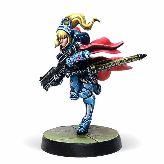 A side view of the painted Jeanne d'Arc 2.0 Infinity miniature, showing the detail on her rifle and red cape.