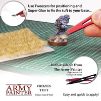Advertisement for The Army Painter's Frozen Tuft and tools on a green cutting mat.