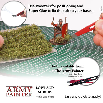 Modeling kit with lowland shrubs, tweezers, and Super Glue on a grid surface, featuring The Army Painter branding.
