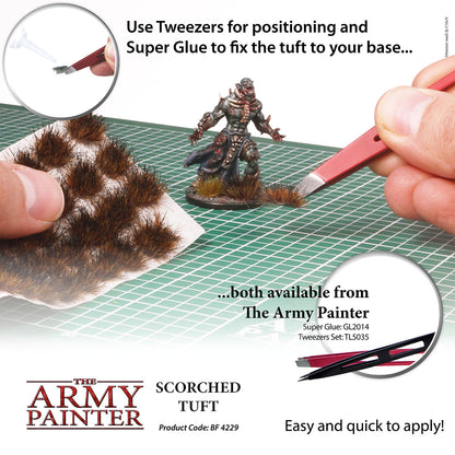 Model painting tutorial with tweezers and super glue on a grid surface, featuring The Army Painter branding.