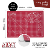 Red cutting mat with grid lines and measurements, branded 'The Army Painter', on a white background.