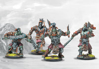 Four individual painted W'adrhŭn Chosen of Conquest/Veterans models, displaying various heavy weapons and detailed tribal armor.