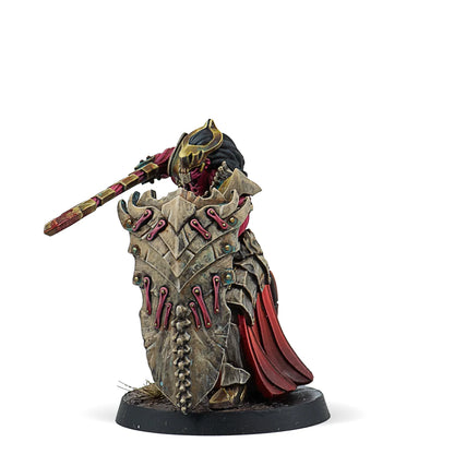 A painted Warcrow miniature of a Scion of Yaldabaoth Anointed, a warrior holding a large, ornate shield.