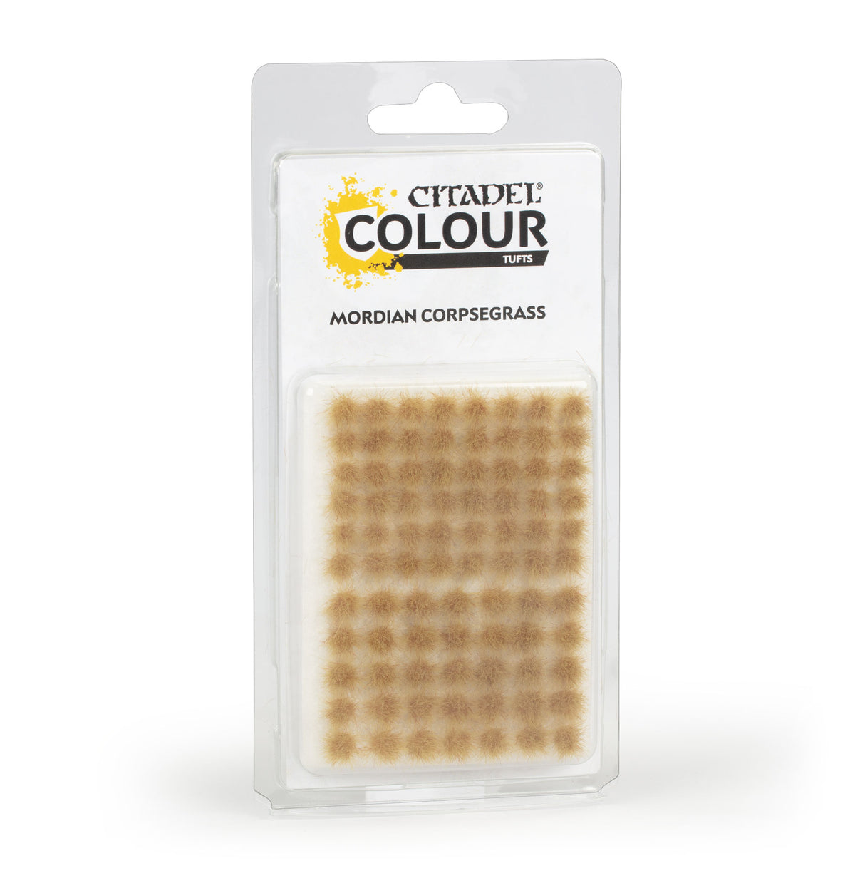 The official retail packaging for Warhammer Colour Mordian Corpsegrass Tufts displaying various sizes of self-adhesive grassy tufts.